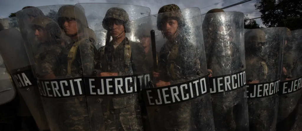 A row of Honduran military holding riot shields during 2017 elections. Photo: Sean Hawkey
