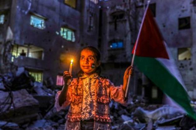 Girl holds candle in Gaza Strip