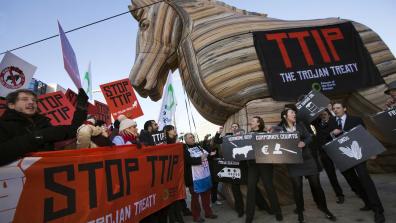 A demonstration to 'Stop TTIP', with a giant inflatable wooden horse and a banner on it that reads "TTIP: The Trojan Treaty". 