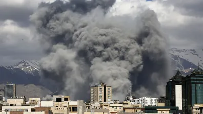 Buildings with grey smoke clouds behind