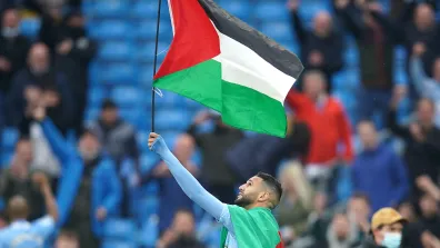 Manchester City's Riyad Mahrez with a Palestine flag